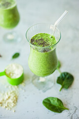 Healthy green protein smoothie, packed with spinach, banana and vanilla protein powder, topped with chia seeds, great for weight loss, detox and a rich source of vitamins, minerals, and antioxidants