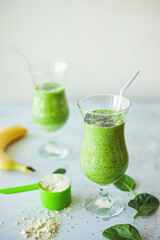 Healthy green protein smoothie, packed with spinach, banana and vanilla protein powder, topped with chia seeds, great for weight loss, detox and a rich source of vitamins, minerals, and antioxidants
