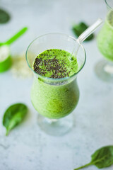 Healthy green protein smoothie, packed with spinach, banana and vanilla protein powder, topped with chia seeds, great for weight loss, detox and a rich source of vitamins, minerals, and antioxidants