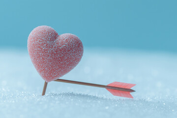 a heart made of snow with an arrow