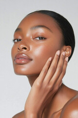 woman with smooth skin gently touches her cheek, showcasing natural beauty and elegance. soft focus highlights her serene expression and flawless complexion