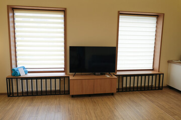 Room of a modern country hotel with windows and TV