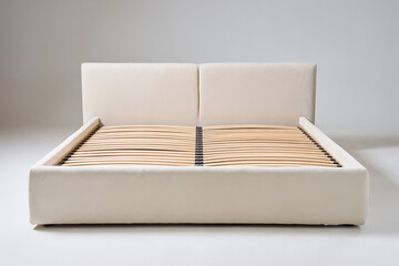 A modern bed design featuring a wooden slatted base paired with an upholstered frame, ideal for...