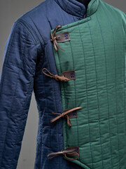 Historical fashion. Medieval knight cloth. Padded jacket gambeson.