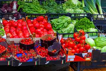 Fresh organic red tomatoes outside on a market stall