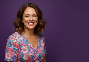 Fototapeta premium Middle-aged woman happy on purple background