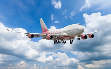 Airplane flying in blue sky with clouds, travel background