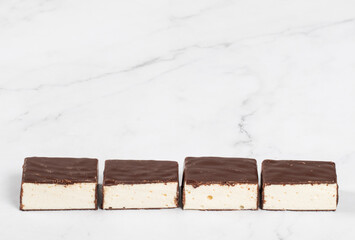 Vanilla souffle in chocolate glaze. Bird's milk. White background. Copy space