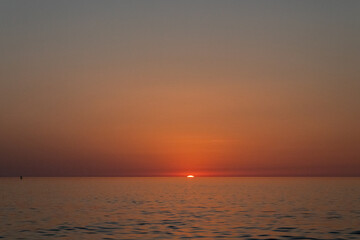 sunset on sea sky background, sunset sky, clouds over sea in evening with orange, yellow sunlight in golden hour