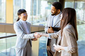 Business professionals engage in productive conversation at modern office setting in daylight