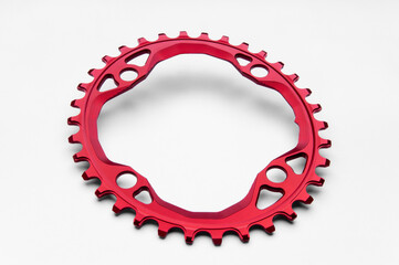  Red oval bicycle chainring against white isolated background, lies flat on the surface. Professional bicycle part.