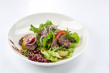 salad with beef in the white plate