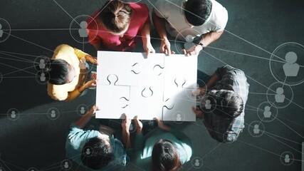 Top down view of business people gathering jigsaw together at meeting. Aerial view of diverse team collect or put piece of white puzzle together with computing global networking community. Symposium. - Powered by Adobe