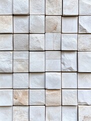 White and Beige Stone Tile Wall - Close-up of a wall composed of small, square, off-white and beige stone tiles.  The tiles vary slightly in shade and texture.
