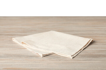 Light napkin on wooden table against white background