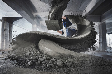 Concrete worker skillfully pouring wet cement in a swirling motion at a construction site