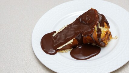 Single Serving of San Sebastien Cheesecake with Chocolate Drizzle Isolated on White plate