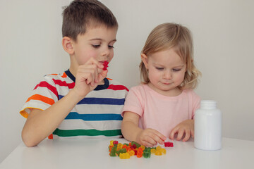 Children eating jelly candies. Deliciousness and vitamins.