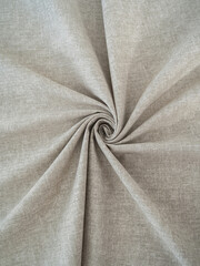 Soft beige fabric. Beautiful folds. Closeup.