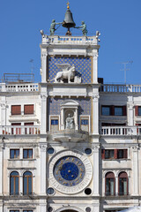 St Mark's Clock tower on Piazza San Marco, Lion of Saint Mark relief on facade, Venice, Italy