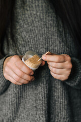 Young woman takes wooden toothpick out of box with her hands for cleaning teeth. Photography,...