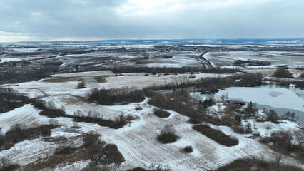 Meadow drone aerial winter landscape snow floodplain frost Plane loucky fog morning over nature snowy reserve, Litovelske Pomoravi icy protected landscape area, pond ice plants, willows, field Europe
