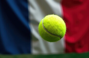 Tennis ball flying across french flag, close-up. Championships, game, professional sports or hobby, international tournament.