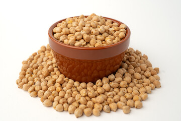 Chickpeas in a bowl on a white background with many scattered around, isolated,  raw uncooked legumes, healthy organic food, high-protein vegetarian ingredient, nutritious dried peas, agriculture
