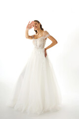Fototapeta premium Elegant bride in a flowing white gown posing gracefully against a light background during a bridal photoshoot