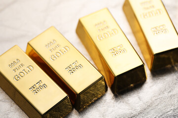 Many gold bars on silver background, closeup