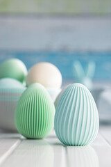 Easter decoration. Colorful eggs on white table.