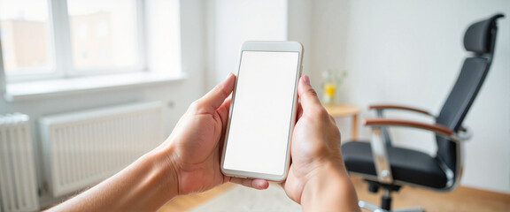 Hand holding smartphone in contemporary office setting, digital connectivity