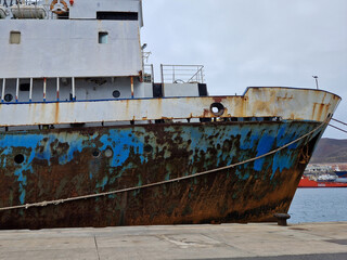 Rusty ship moored at port