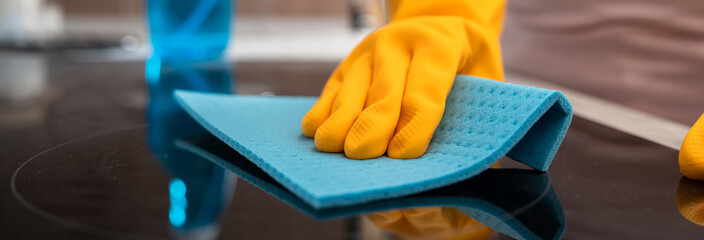 Housekeeper cleaning the kitchen, gas stove, cleanliness concept