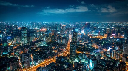 Night cityscape with illuminated roads and towering skyline