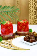 Refreshing mix fruits ice with coconut, watermelon, grapes and red syrup. Iftar drink and dates fruit for ramadan month in Indonesia.