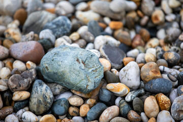 Rocks and pebbles along Marazion Beach in Cornwall, UK.