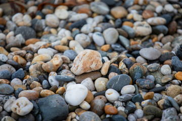 Rocks and pebbles along Marazion Beach in Cornwall, UK.