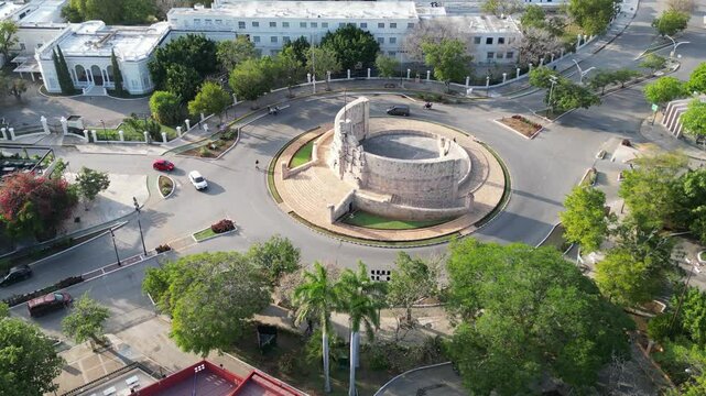 aerial view of monument of la patria on boulevard paseo de montejo in merida yucatan mexico (national heritage monument to the homeland) travel tourism destination with traffic going around a circle