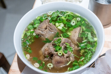 Overhead shot of Oxtail Soup with broth and green onion and cilantro