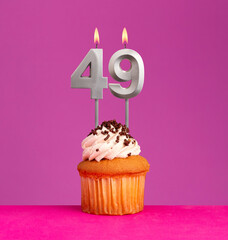 Birthday card on violet background - Candle number 49.