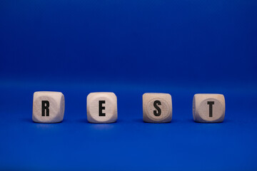 Rest word on small cubes for relaxation and wellness concept