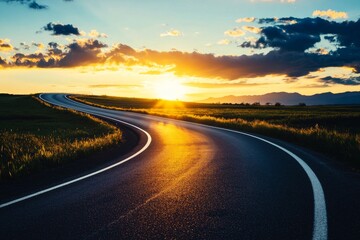 Dramatic sunset over a rural landscape with an empty asphalt road