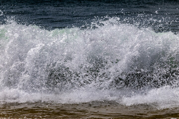 Frozen wave breaking on  to sandy beach