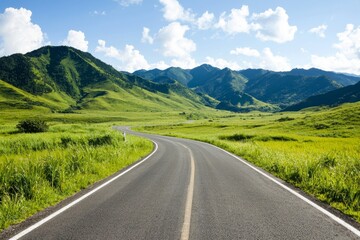 Naklejka premium A rural road winds through lush green grass set against a stunning mountain backdrop under a brilliant blue sky