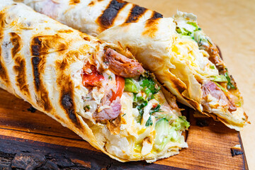 Delicious grilled wraps with fresh vegetables and meats