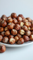Obraz premium whole hazelnuts on white plate