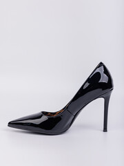 Black women's leather high-heeled pumps made of leather, isolated on a white background. Women's fashionable classic shoes