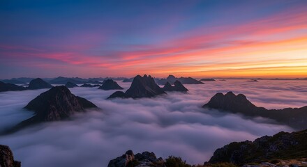 Majestic Mountain Peaks Above Cloudscape at Sunset