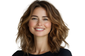 Smiling woman with wavy hair poses against a light background in a casual setting